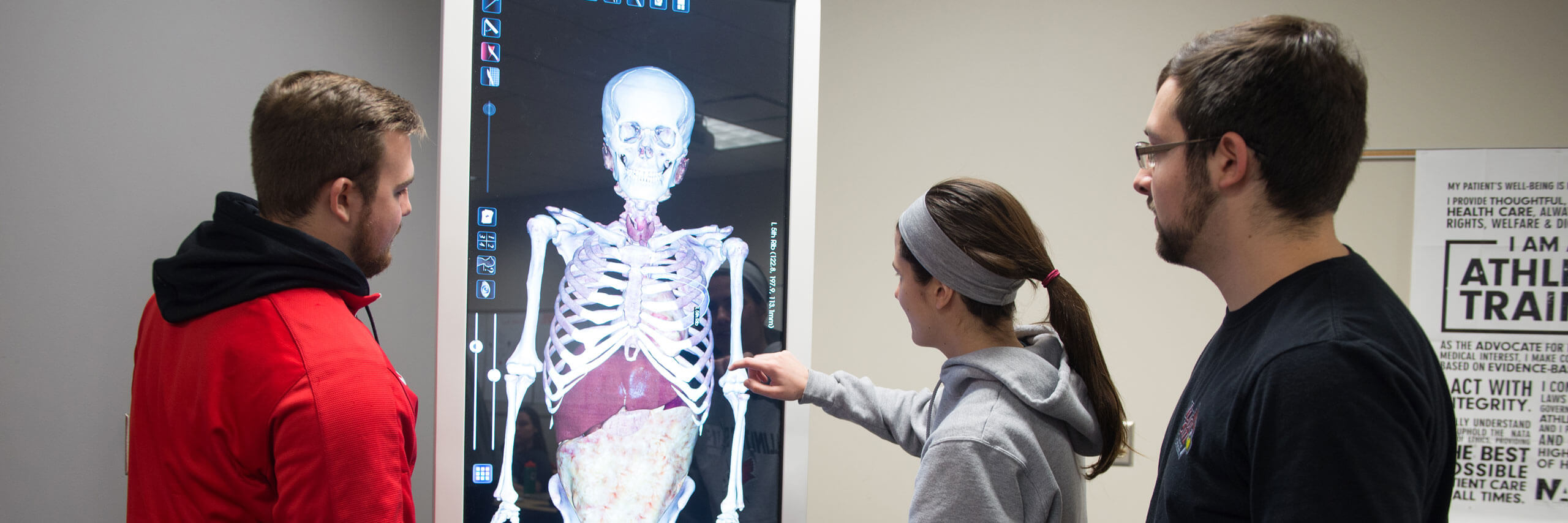 Students analyze a digital scan of a human body.