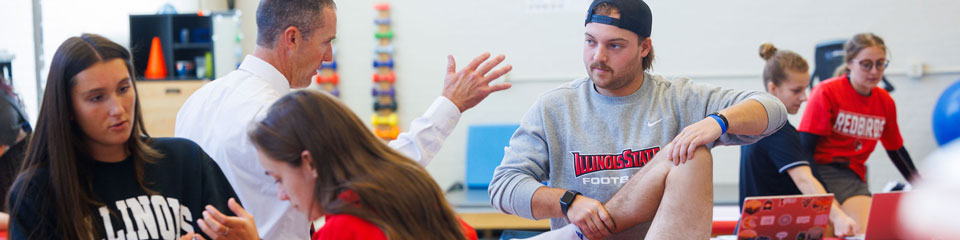 People engaging in a practical exercise in a classroom setting.